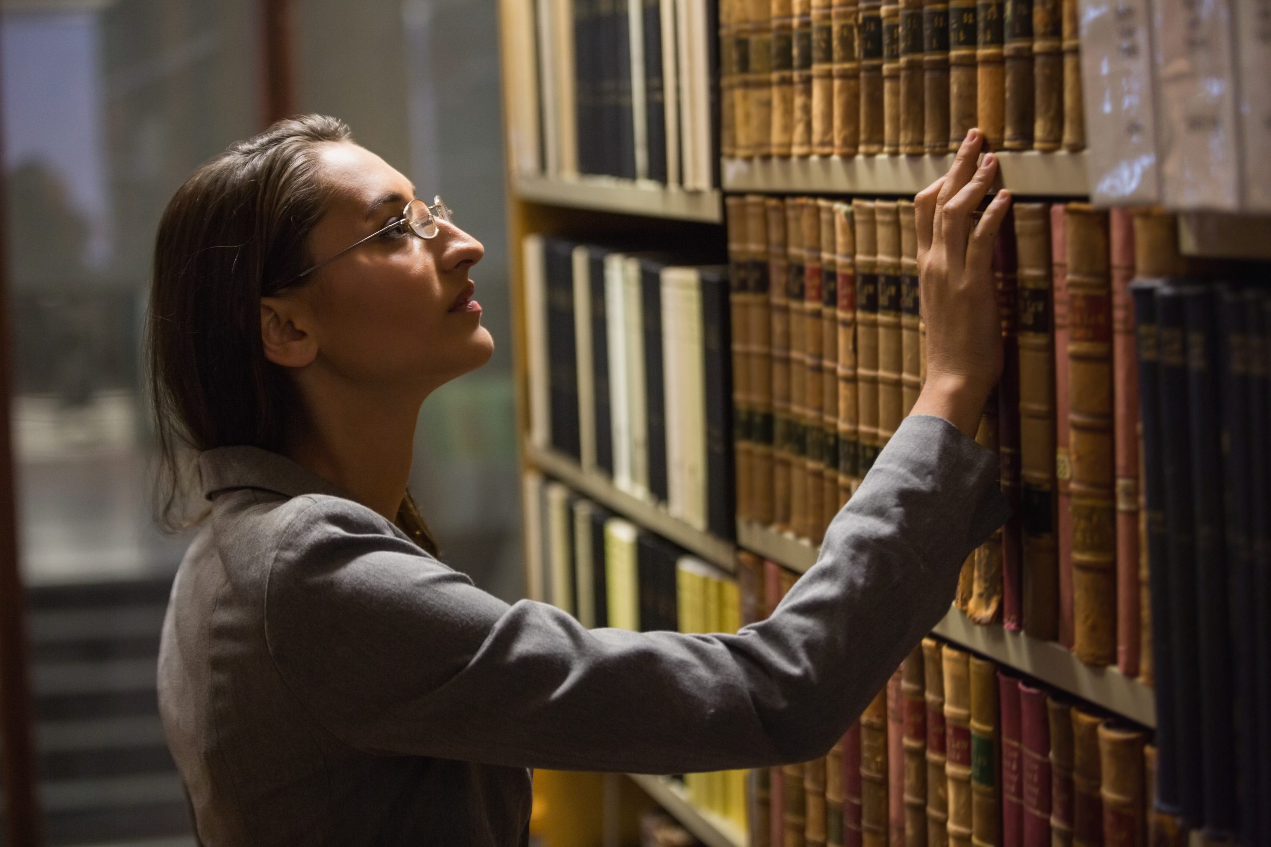 Lawyer picking book in the law library at the university