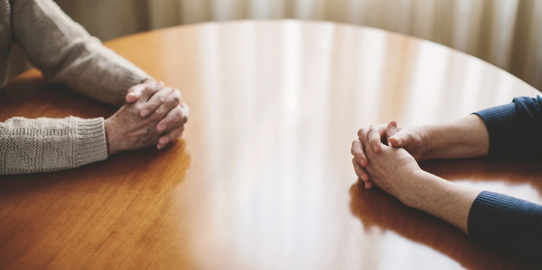 table with couple hands